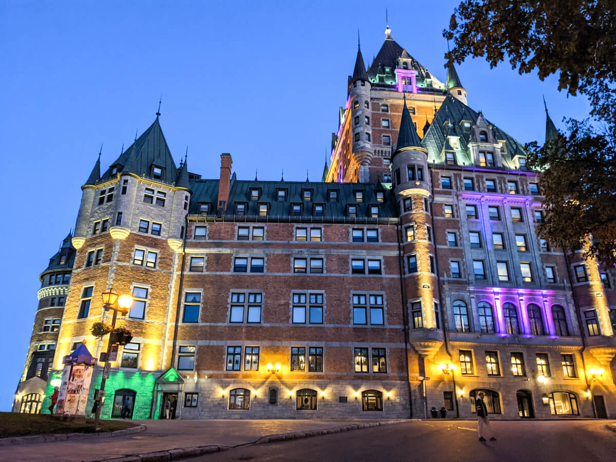 standing at the chateau frontenac in quebec city at night