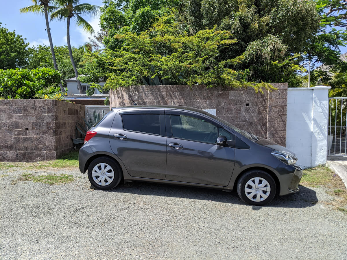 car sitting a hotel parking lot in antigua with minor damage 