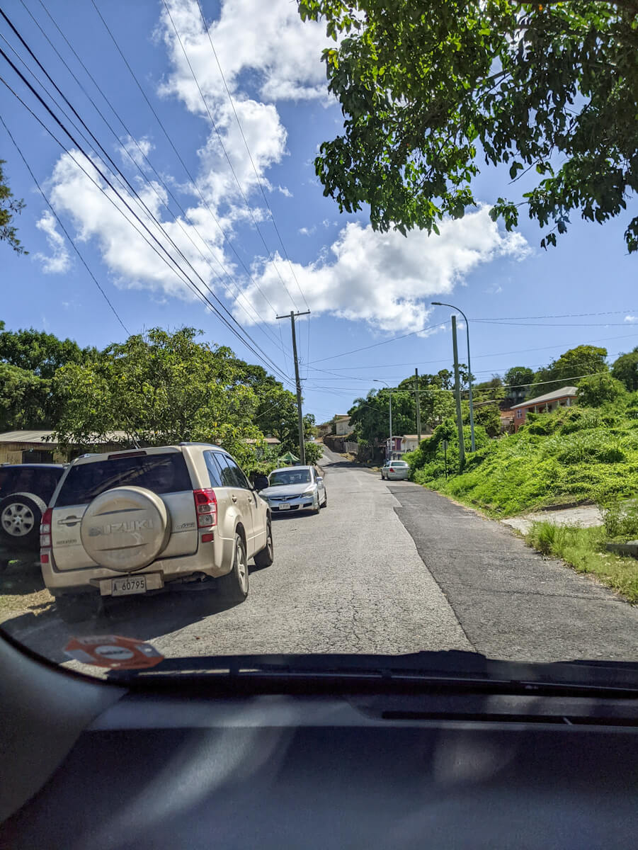 cars parking at the side of the road in antigua