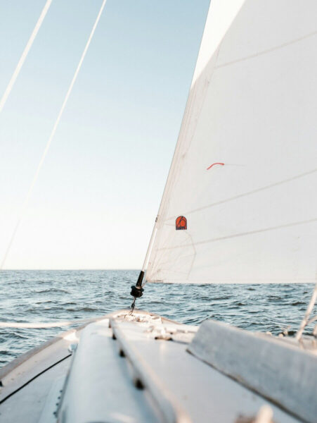 front of a sailboat sailing in the clear waters of Aruba